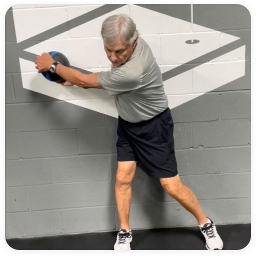 Senior Citizen practicing a golf swing with a weighted ball